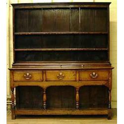 An 18th century oak dresser with plate rack a...