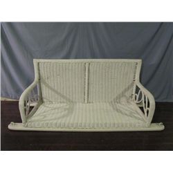 White wicker porch swing.
