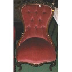 A reproduction nursing chair with carved d...