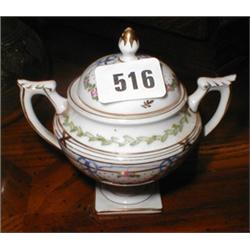 A porcelain twin-handled lidded pot...