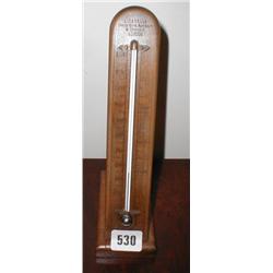 A wooden mounted standing thermometer by A...