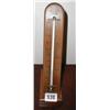 A wooden mounted standing thermometer by A...