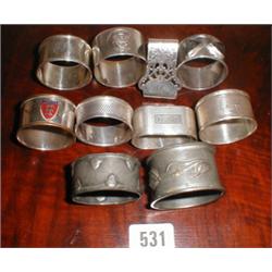 Six silver napkin rings together with two ...