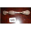 A pair of silver filigree sugar tongs...