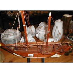 A model wooden boat (carved from one piece...