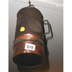 A copper based lamp with carrying handle...