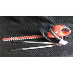 B&D Hedgehog electric trimmer and branch pruner .