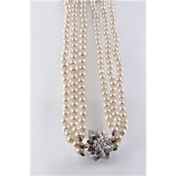 A Three Strand Pearl Necklace with White Gold and Diamond Clasp
