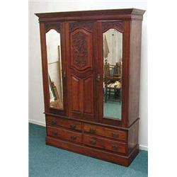 Edwardian carved walnut triple wardrobe, the