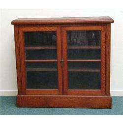 Oak dwarf bookcase, fitted a pair of glazed d