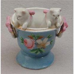 Small porcelain cats in a flower vase ornamen