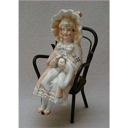 Bisque model of a young girl with a frilled h