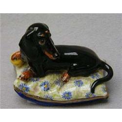 Small hand painted model of a sausage dog on