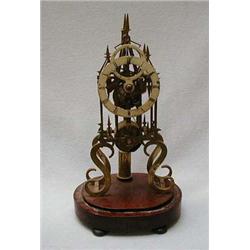 Brass Gothic style skeleton clock on an oval