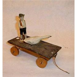 Boy and goose, on wheels, made of wood and pa