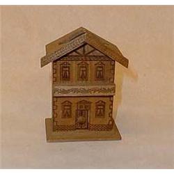 Saving box of wood shaped as a house, h 9 cm.