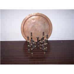 Collapsable carved table with copper top.