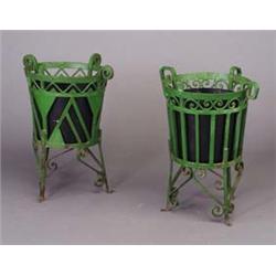 Two Art Deco green enameled cast-iron footed