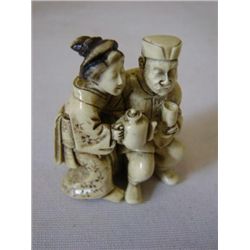 ET0503120123 Carved orental Ivory Netsuke of a man and