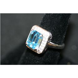 Sterling Silver Ring W/Blue Gemstone Surrounded by White Gemstones