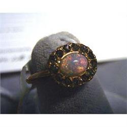 10k lady's antique ring. Yellow gold with simulated glass opal  center stone. There are twelve glass