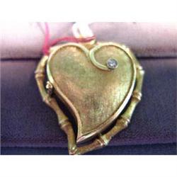 14k lady's locket. Yellow gold heart-shaped locket. .05 carat  round brilliant diamond. 10.0 grams $