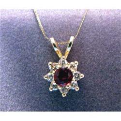 Lady's 14k  ruby and diamond pendant, with 8 full cut diamonds  surrounding 4mm round ruby. Estimate