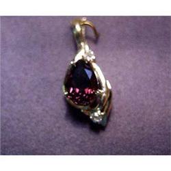 Lady's 14k pearl enhancer with garnet. Pendant is 14k yellow gold  with 2 carat pear cut garnet and