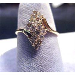 Lady's 14k diamond ring with 16 full cut diamonds. Diamond total  weight is .50 carats. Ring size is