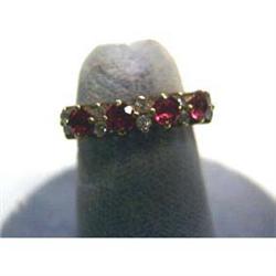 Lady's ruby and diamond ring. Yellow gold ring is 10k with four  round rubies and ten diamonds. Ring