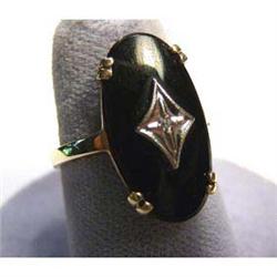 Lady's black onyx ring with diamond. Ring is 10k yellow gold. Ring  size 7.