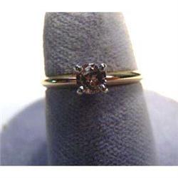 Lady's 14k yellow gold ring with fancy 4mm colored diamond. Diamond  weight is .25 carats. Ring size