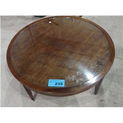 Mahogany finish round cocktail table with galss