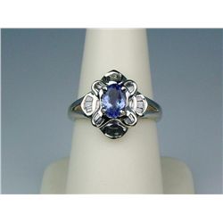 Splendid 14K WG Ladies Contemporary Design RingSet with a center oval Tanzanite weighing  over 1.00 
