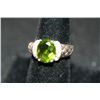 Sterling Silver Ring W/Oval Shaped Green Gemstone Surrounded By White Gemstones