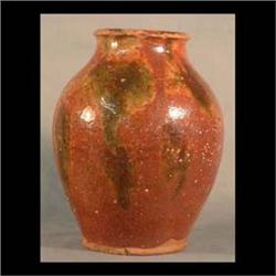 Redware pot. Brown, green, and tan color. 19th century. Frog skin, high glaze. Note pitting and rim
