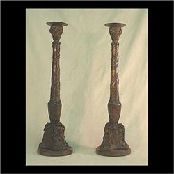 Pair of carved oak candlesticks. Carved with oak leaves, acorns,  and twigs with brass inset candleh
