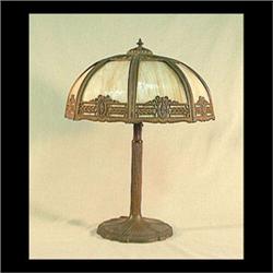 Slag glass lamp attributed to Miller. Eight caramel colored bent  glass panels held by decorative pi