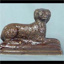 Rockingham reclining dog. Expansion crack done in the making. 6 1/2"h x 9" $170-250