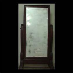 Empire style mahogany dressing mirror. Ogee shaped frame contains a  beveled mirror mounted in a swi