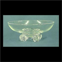 Steuben clear glass footed bowl. Simple formed bowl rests on four  scrolled feet. Signed Steuben. 3"