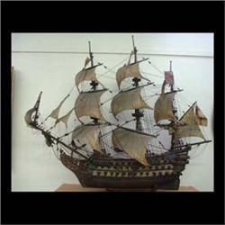 Model of an early British battleship. Ship has seventy-four  cannons, twelve sails, and a carved hea