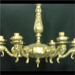 Ornate polished brass chandelier, six stylized figural lion arms  with acanthus leaf decoration. 22"