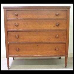 Sheraton four-drawer chest. Birch and other mixed woods. Reeded  molding around the top. Reed carvin