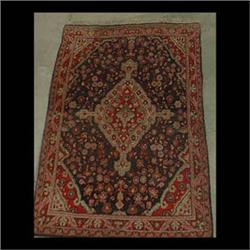 Oriental rug. Central diamond shaped medallion in reds, beige, and  green on a gray and black field.