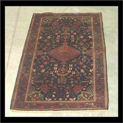 Sarouk Oriental rug. Pink diamond shaped central medallion on a  dark blue ground, with stylized flo