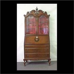 Slant-front writing desk with bookcase above. Ornate scrolled  cornice, lattice work on doors above