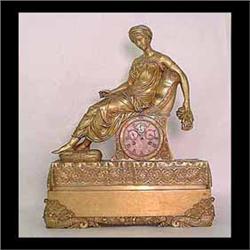 Bronze French figural clock. Classical style with seated female  figure and a clock below, mounted o