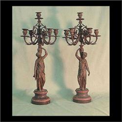 Pair of spelter figural candelabras resting on a marble plinth. Two  female figures carry a vase on