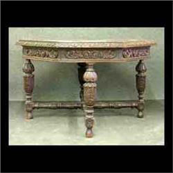 Octagonal oak table with carved skirt and apron. Legs and stretcher  carved and turned with acanthus